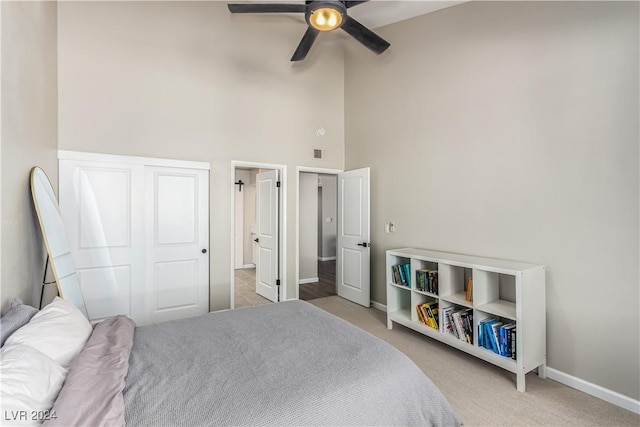 carpeted bedroom with a closet and ceiling fan