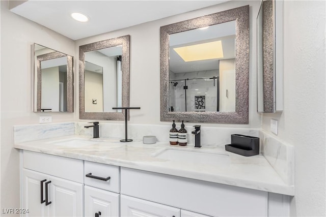 bathroom featuring vanity and an enclosed shower