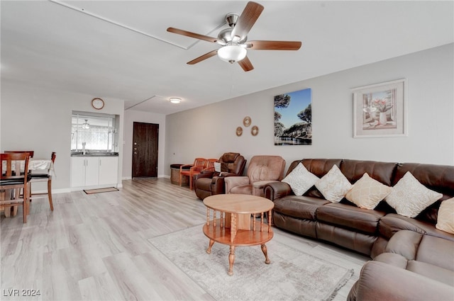 living room with light hardwood / wood-style flooring and ceiling fan