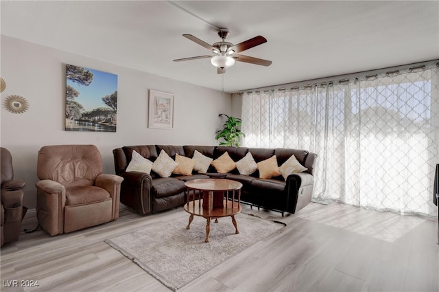 living room with ceiling fan and light wood-type flooring