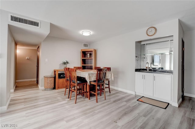 dining area featuring light hardwood / wood-style flooring and sink