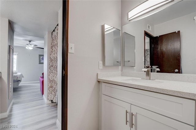 bathroom with hardwood / wood-style flooring, vanity, and ceiling fan