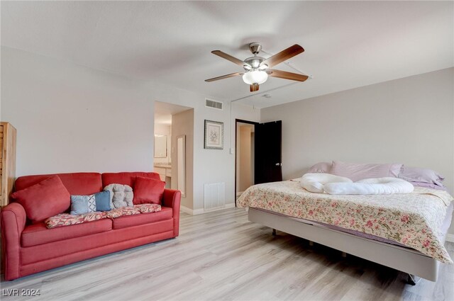 bedroom with ensuite bath, ceiling fan, and light wood-type flooring