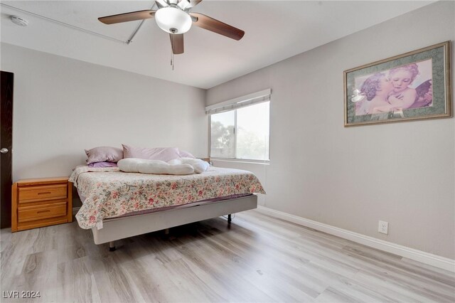 bedroom with ceiling fan and light wood-type flooring