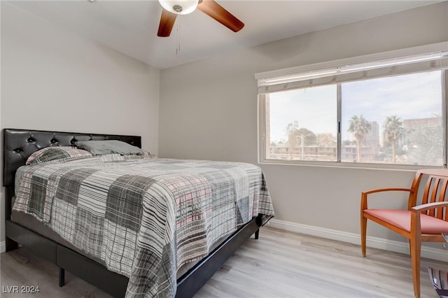 bedroom with ceiling fan and light hardwood / wood-style floors