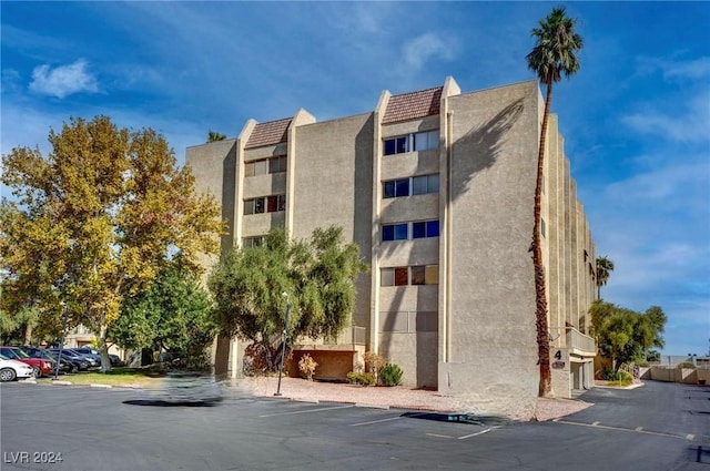 view of property featuring uncovered parking