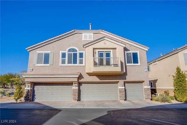 view of front of house with a balcony and a garage