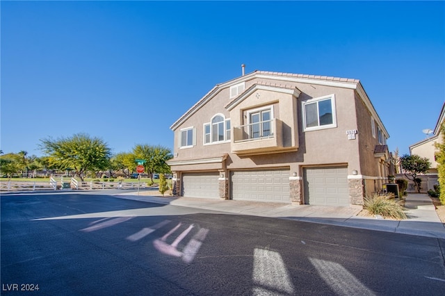 view of front of home featuring cooling unit and a garage