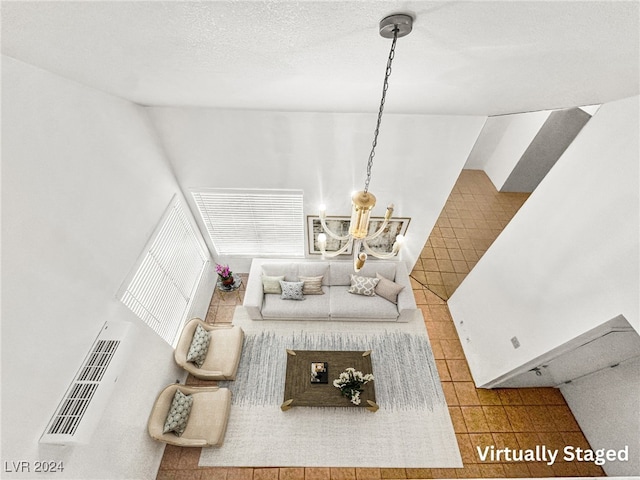 living room featuring tile patterned flooring and a textured ceiling