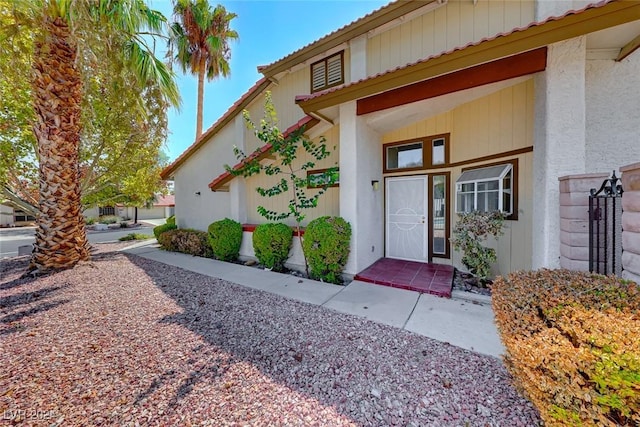 doorway to property featuring stucco siding