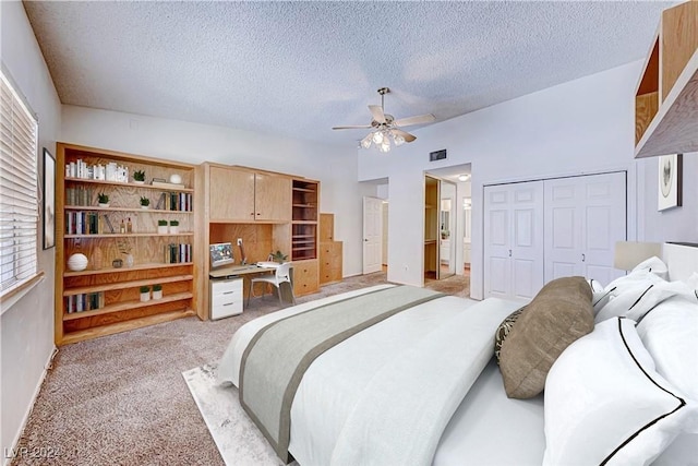 bedroom with visible vents, a textured ceiling, a closet, light colored carpet, and vaulted ceiling