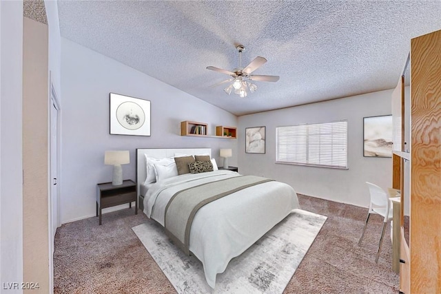 bedroom featuring a ceiling fan, vaulted ceiling, carpet, and a textured ceiling