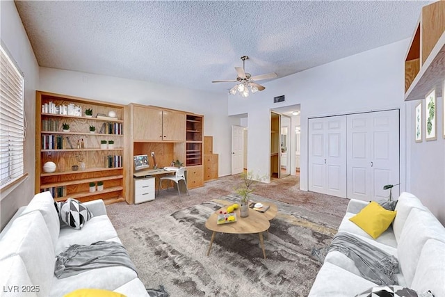 living area featuring light carpet, visible vents, plenty of natural light, and a ceiling fan