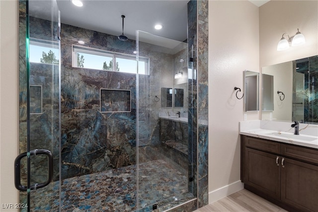 bathroom featuring hardwood / wood-style floors, vanity, and an enclosed shower