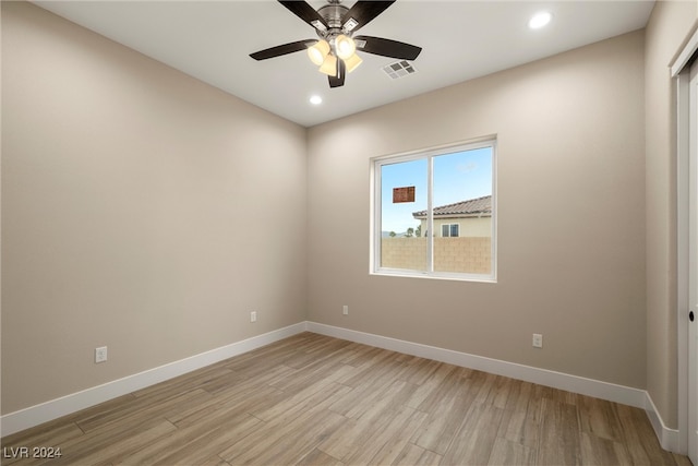 spare room featuring ceiling fan and light hardwood / wood-style flooring