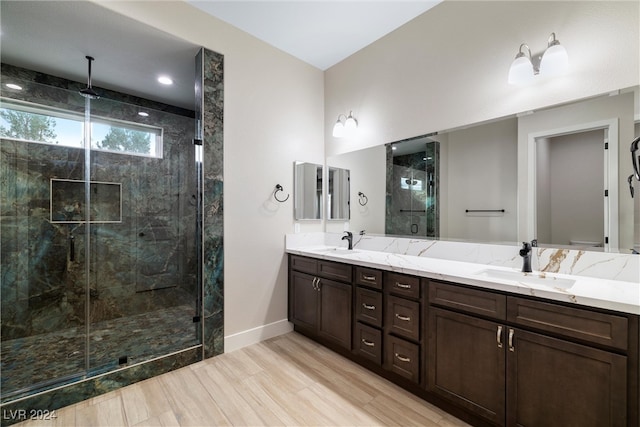 bathroom featuring hardwood / wood-style flooring, vanity, and walk in shower