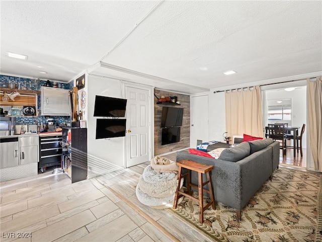 living room featuring light hardwood / wood-style flooring and a textured ceiling