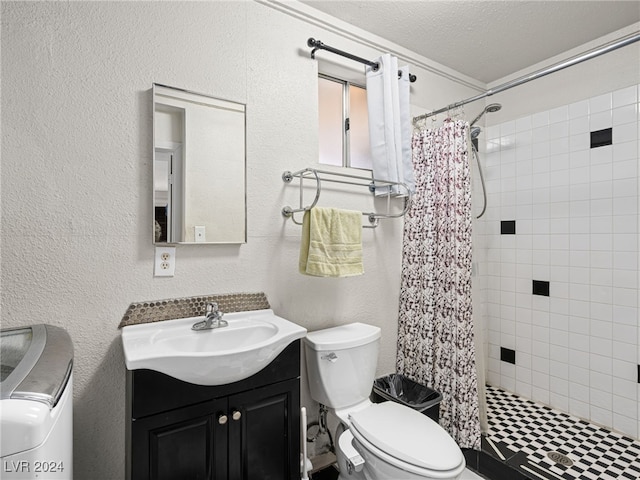 bathroom with a shower with curtain, vanity, toilet, and a textured ceiling