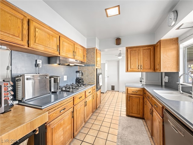 kitchen featuring decorative backsplash, sink, light tile patterned floors, and stainless steel appliances