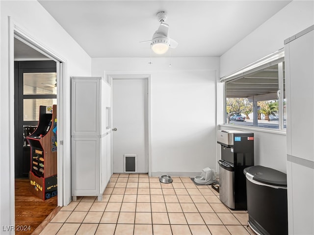 kitchen featuring ceiling fan, white cabinets, and light hardwood / wood-style floors