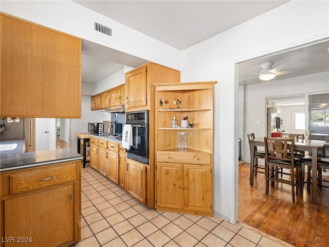 kitchen featuring light hardwood / wood-style floors, oven, and ceiling fan