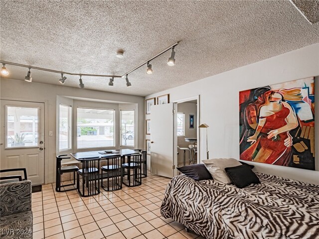 bedroom with light tile patterned floors and a textured ceiling