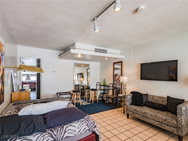 tiled living room featuring a textured ceiling