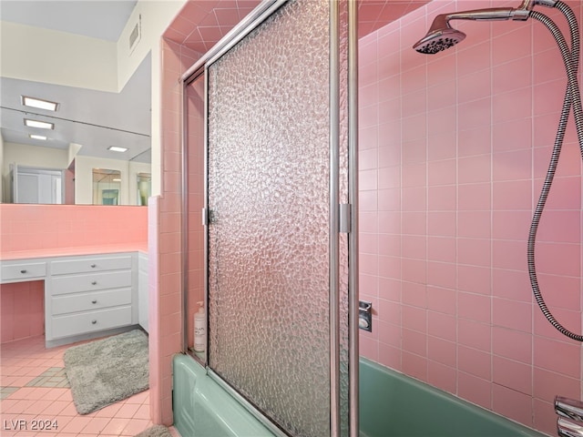 bathroom featuring tile patterned floors, vanity, and bath / shower combo with glass door