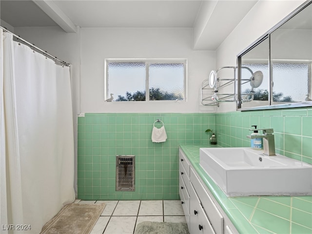 bathroom with tile patterned floors, vanity, and tile walls