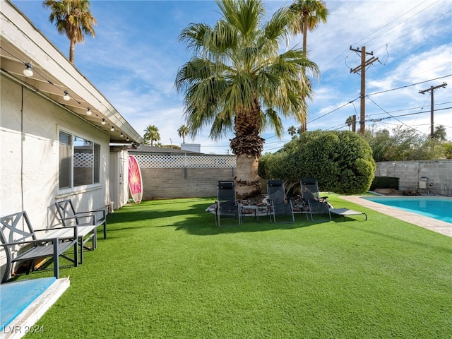 view of yard with a fenced in pool