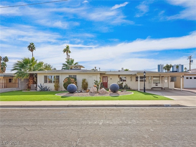 ranch-style house featuring a front yard and cooling unit