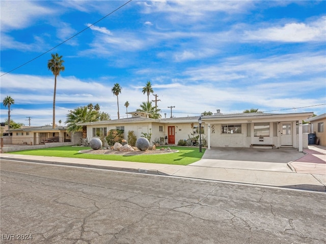 ranch-style home with a front lawn