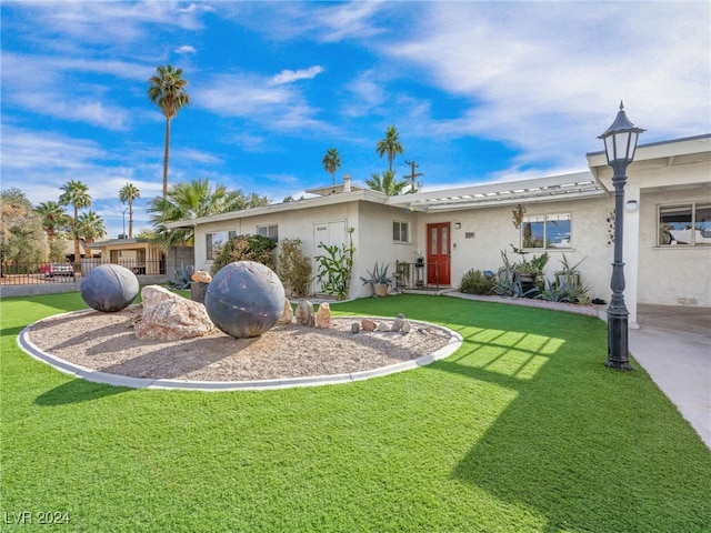 ranch-style home featuring a front yard