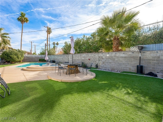 view of yard featuring a fenced in pool and a patio area