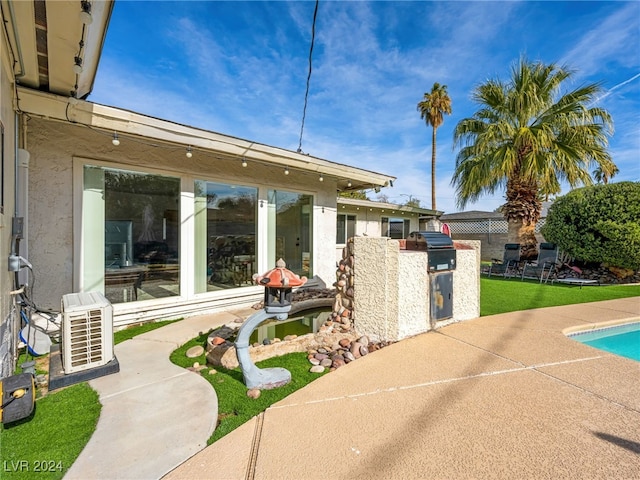 view of patio with area for grilling and ac unit