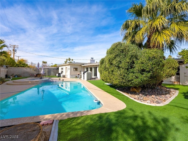 view of pool featuring a lawn and a patio area