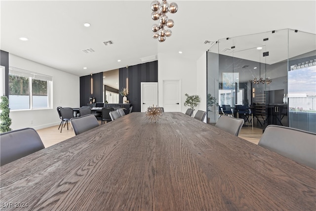 unfurnished dining area featuring a chandelier and light wood-type flooring