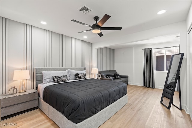 bedroom featuring light hardwood / wood-style floors and ceiling fan