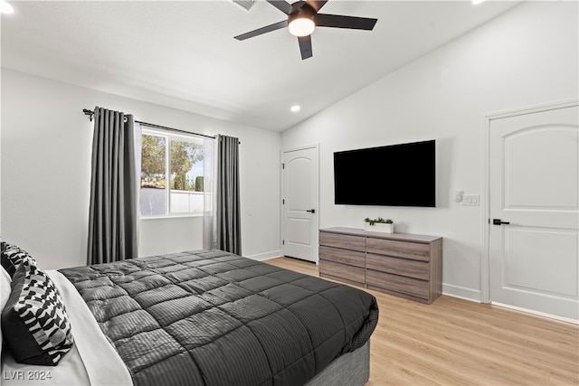 bedroom with light wood-type flooring, vaulted ceiling, and ceiling fan