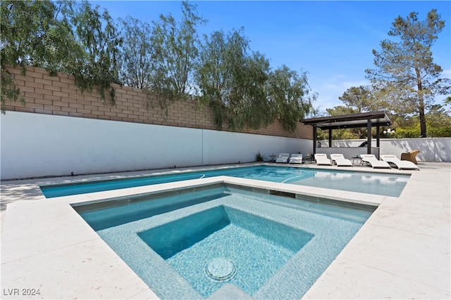 view of pool with an in ground hot tub and a patio