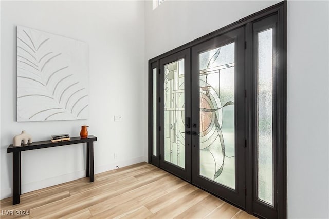 interior space featuring french doors and light hardwood / wood-style floors