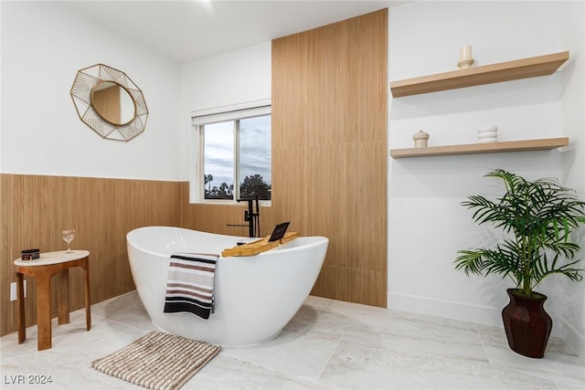 bathroom featuring a washtub and tile patterned floors