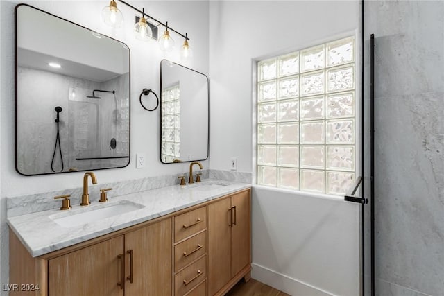 bathroom featuring a shower and vanity