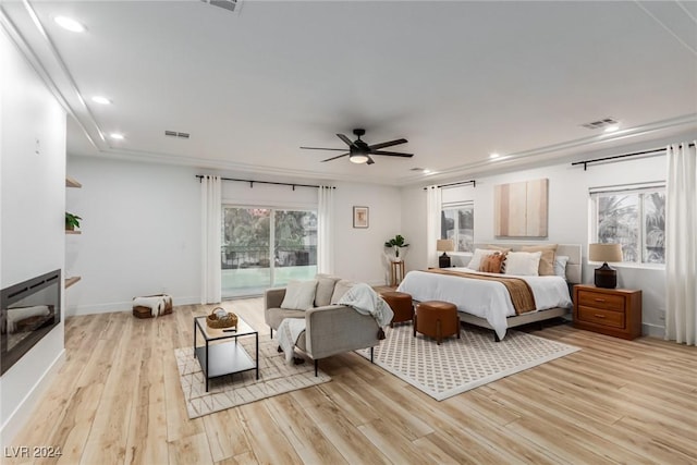 bedroom with ceiling fan, crown molding, and light wood-type flooring