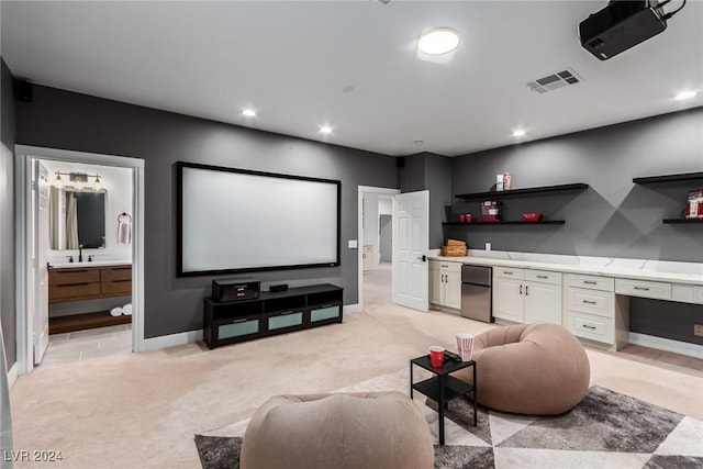 carpeted home theater with sink