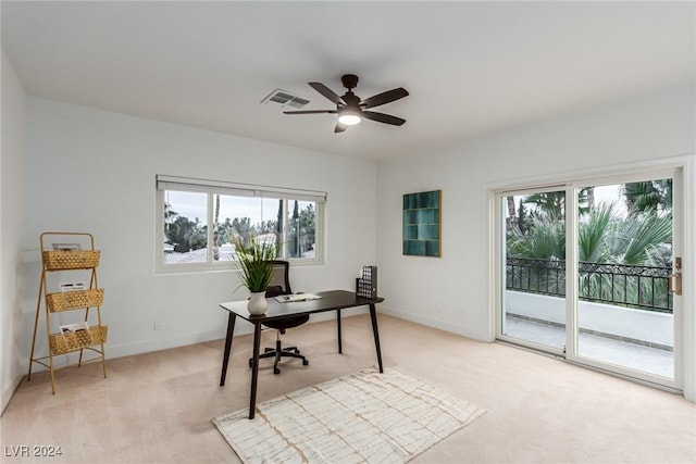 carpeted home office with ceiling fan