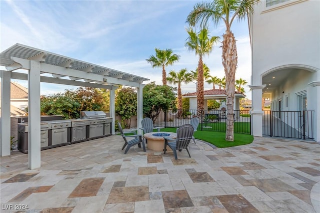 view of patio / terrace featuring exterior kitchen, area for grilling, a fire pit, and a pergola