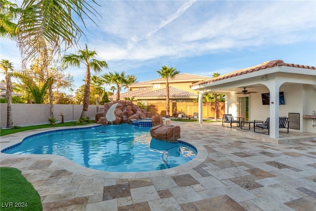 view of swimming pool with a water slide, ceiling fan, and a patio