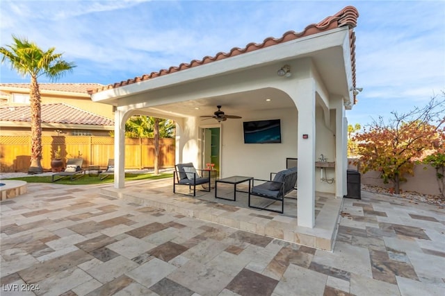 view of patio / terrace with ceiling fan and an outdoor living space