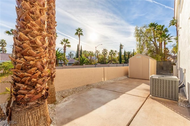 view of patio with central air condition unit and a storage unit